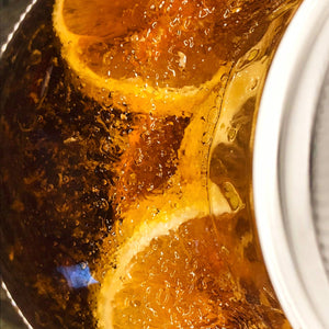 Lemons seeping with honey to produce lemon infused honey from Mill Creek Apiary