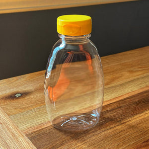 An empty squeeze bottle from Mill Creek Apiary that holds 1lb. of honey